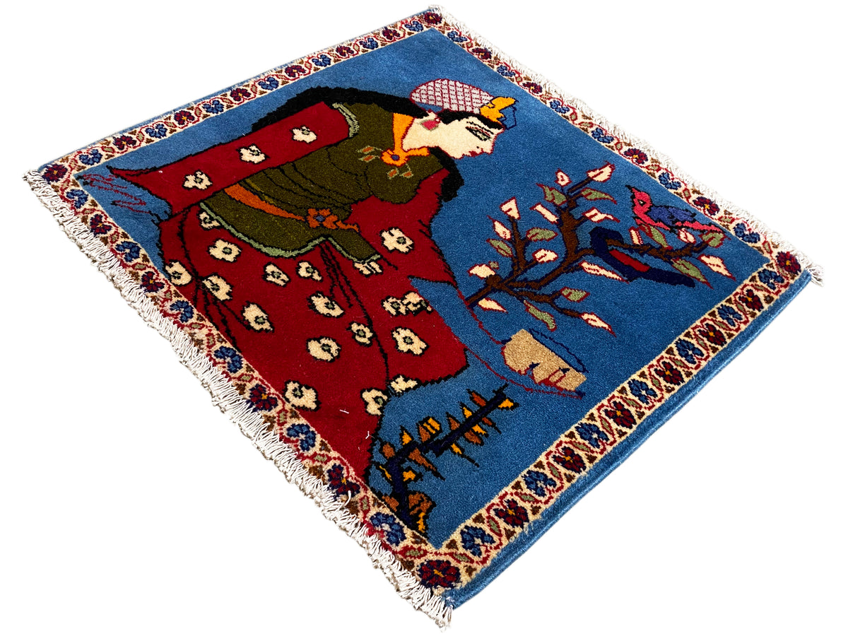 Poshti carpet 65x63 cm in an angled view, figure, red robe and blue ornaments