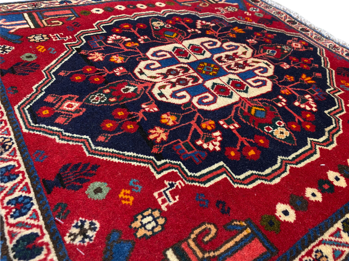 Carpet detail with a dark field and a beige geometric central motif
