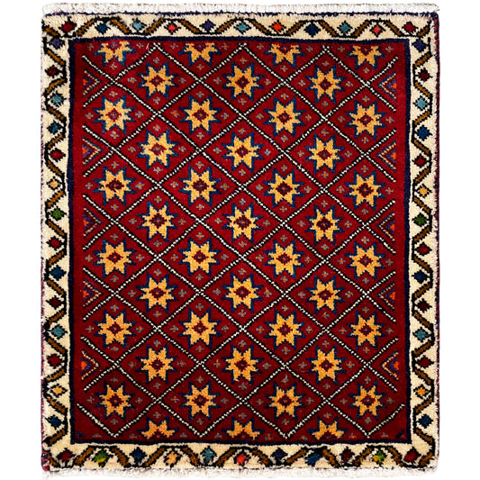Square rug with a red background and a multicolored geometric star pattern